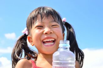 Smiling girl with bottled water