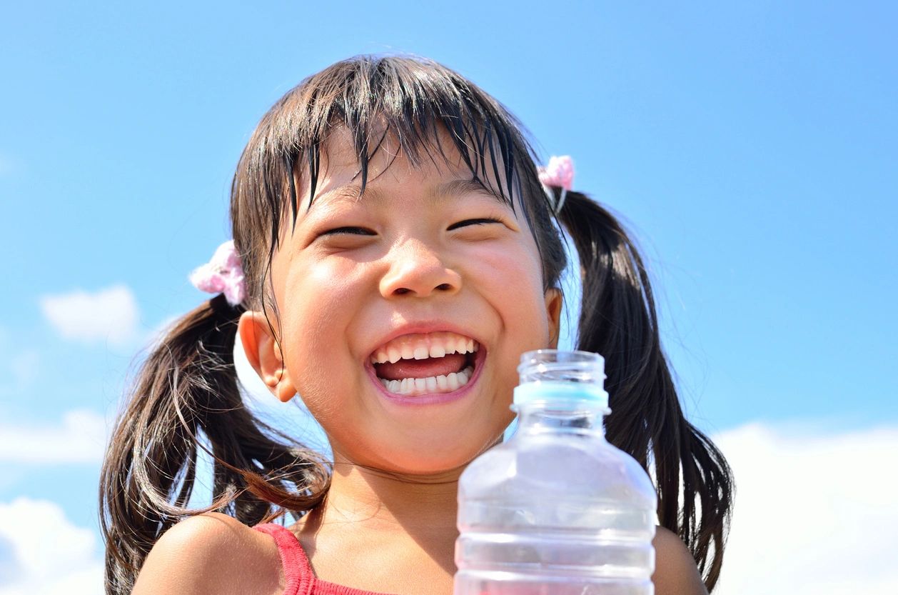 Smiling girl with bottled water